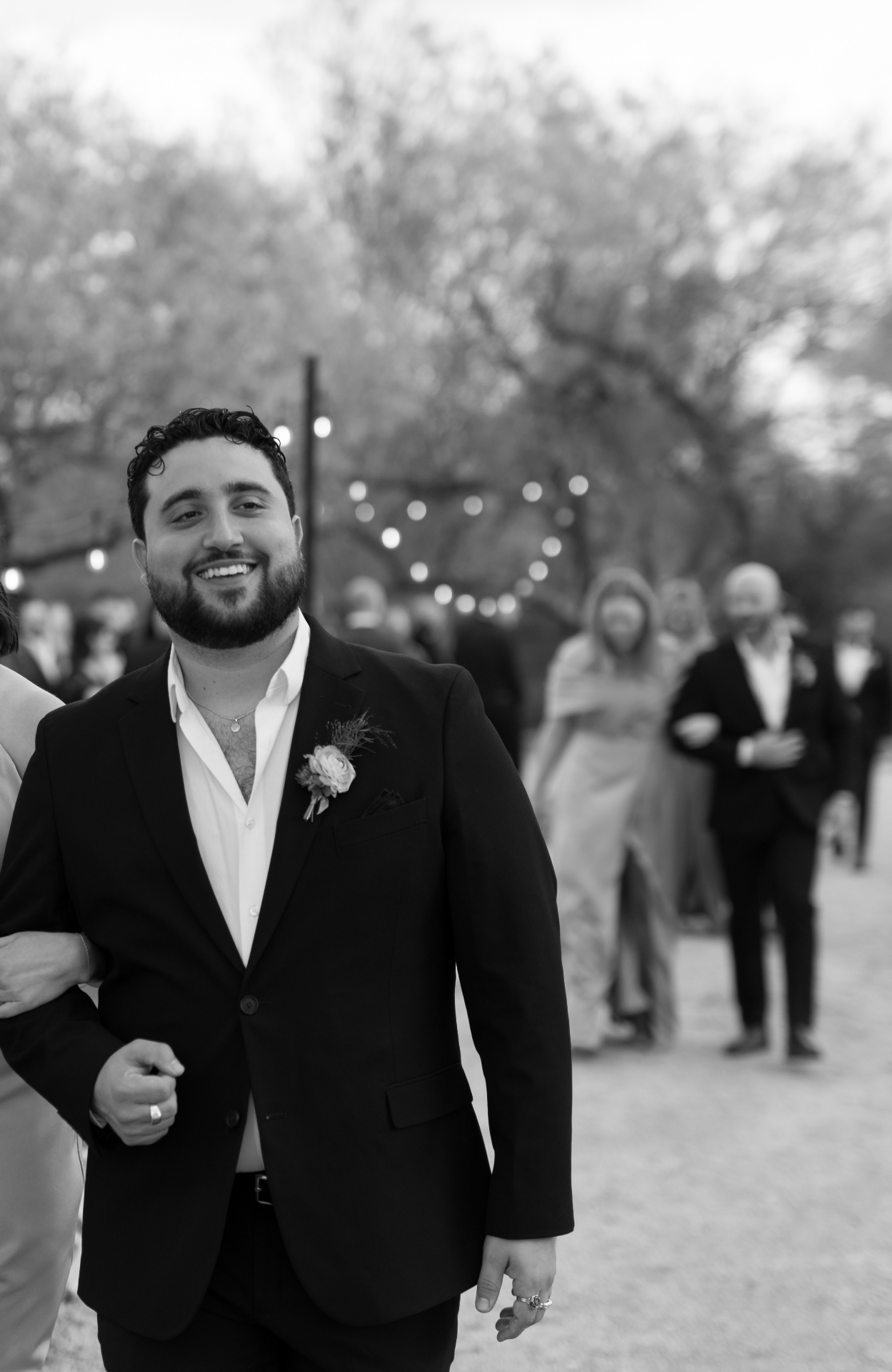 Aaron Alba walking, string lights behind